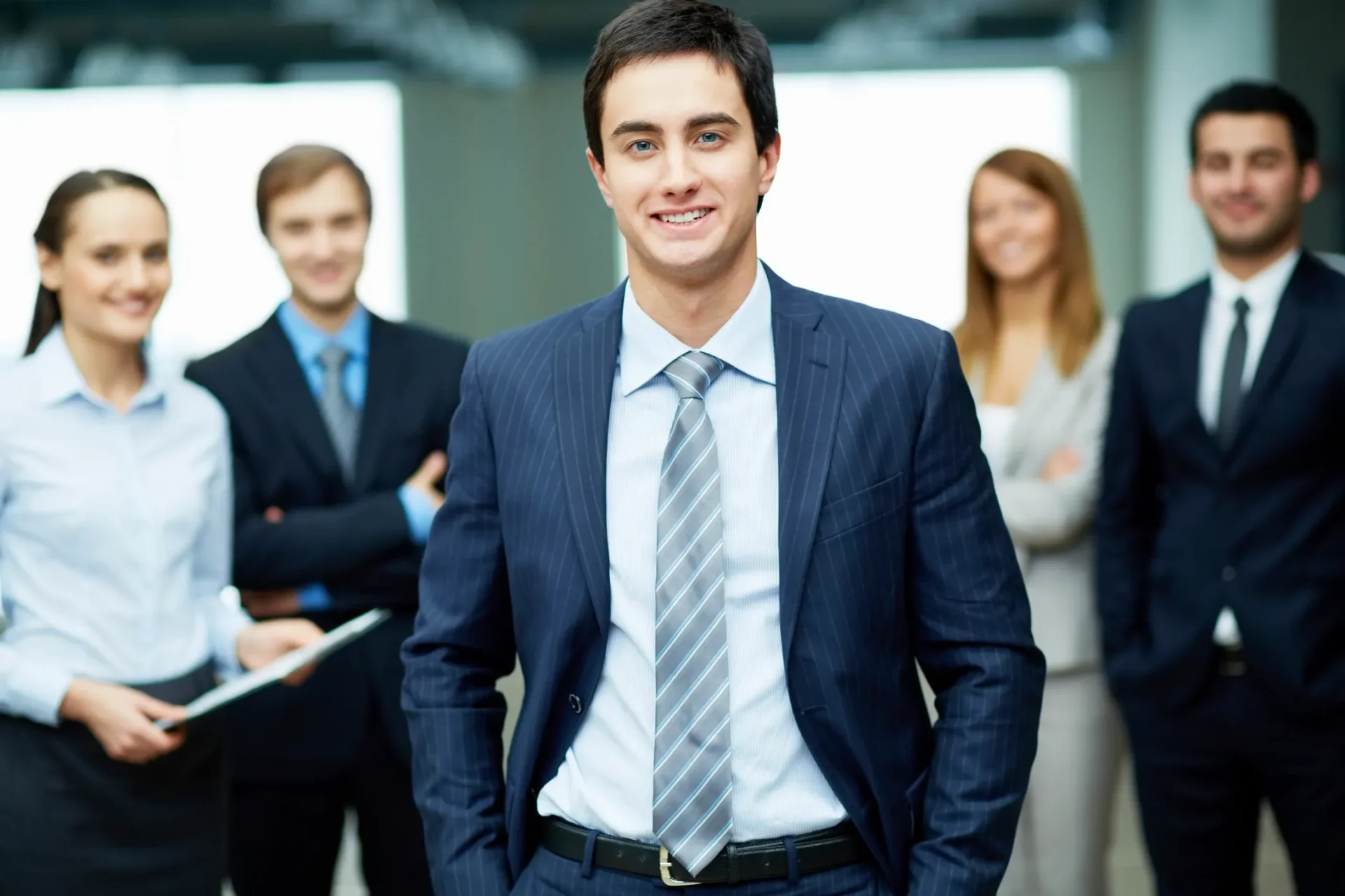 Businessman standing with smiling colleagues