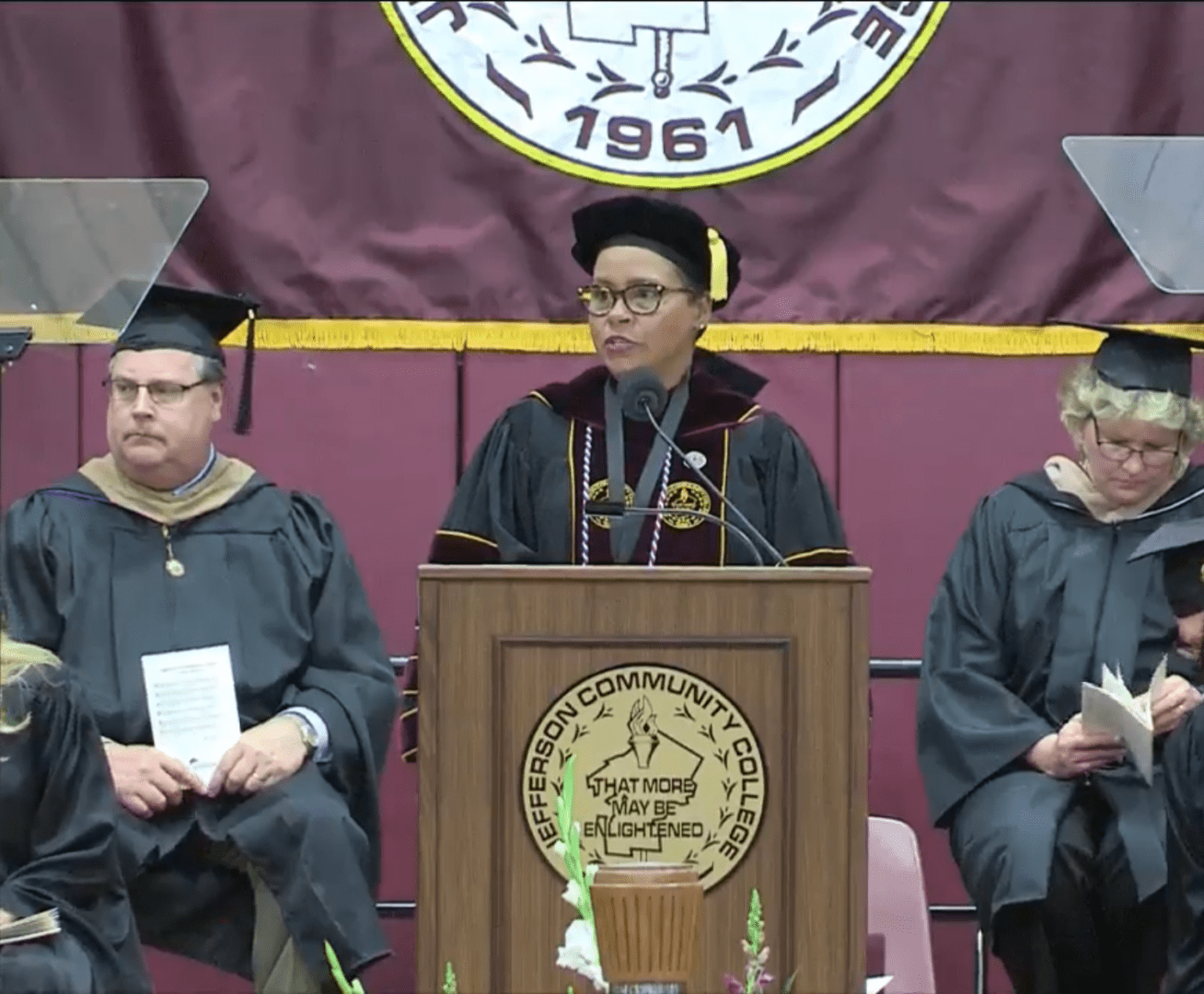 Academic speaker at college commencement podium
